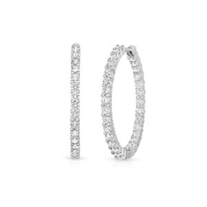 Three diamond tennis bracelets displayed upright and curved, showcasing linked round-cut stones in a silver setting.