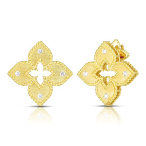 Pair of gold, diamond-studded earrings with a crown-like, leaf-shaped design on a white background with reflections.