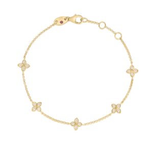 Gold bracelet with diamond-studded four-leaf clover charms on a white background.