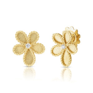 Close-up of two gold floral-shaped jewelry pieces with braided rope edges and a central diamond on a white background