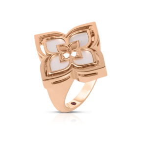 Rose gold ring with a large bow-shaped centerpiece featuring white inlays and a polished finish.