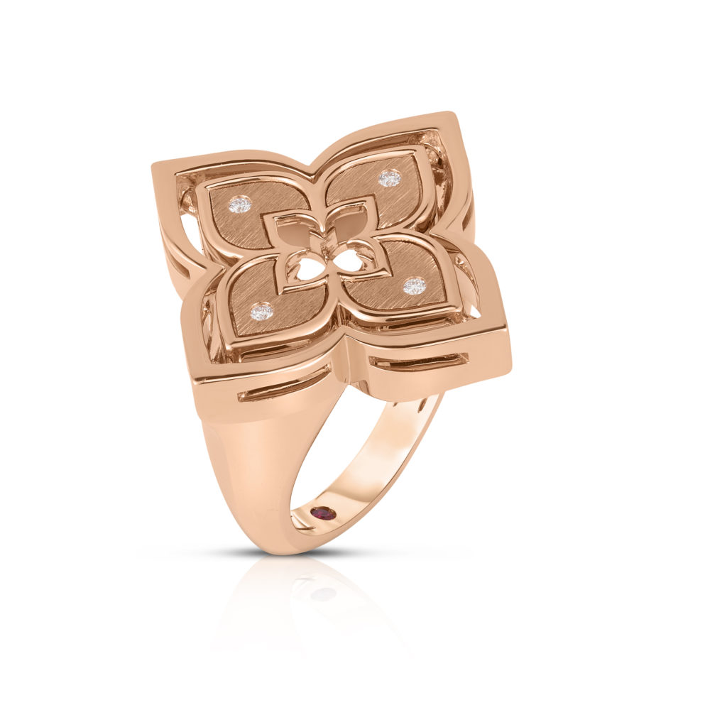 Rose gold ring with a flower-shaped centerpiece and small embedded stones