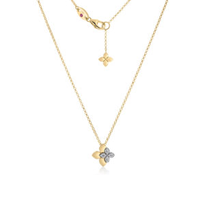 Gold necklace with a four-petaled diamond-studded pendant hanging from a chain