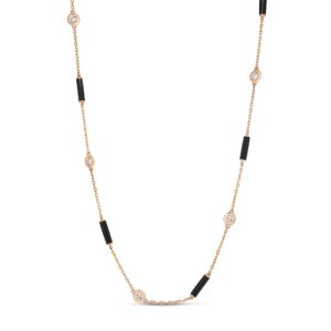 Delicate rose-gold chain necklace with bezel-set diamonds and black cylindrical beads spaced along the chain.